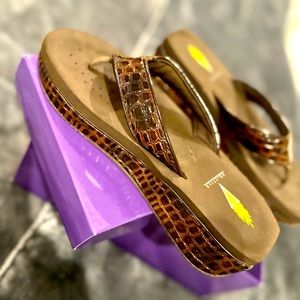 Brown women’s Size 7 sandals with croc print.